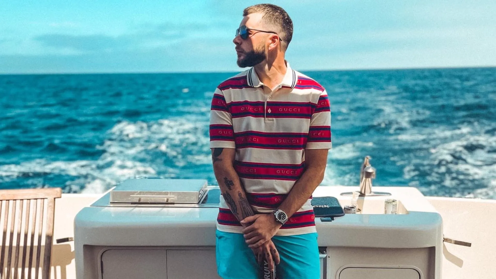 100 Thieves CEO Nadeshot poses in Gucci shirt before collaboration announcement.
