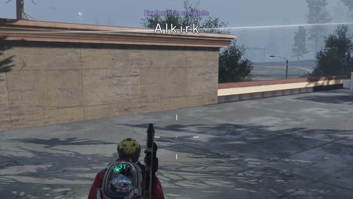 A player on the roof of the Supermarket while the Alkirk Exploration Complete message shows on the screen.